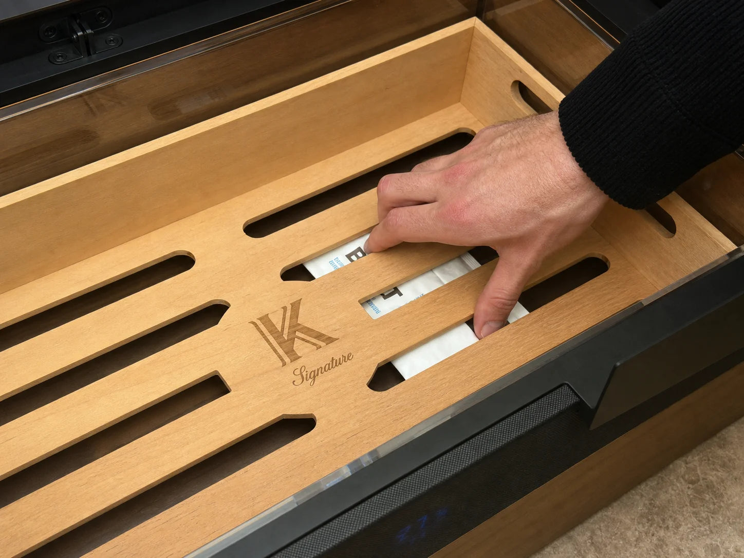 Sliding 69% humidity packs under the bottom Spanish cedar tray of the Signature humidor